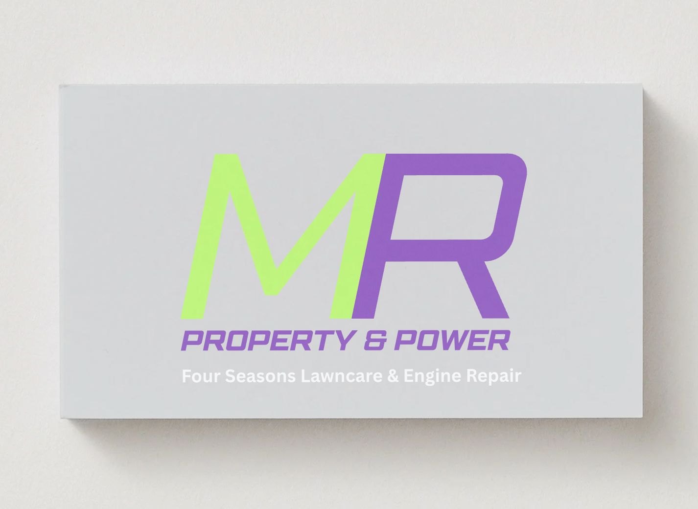 The MR Property and Power business card, the split green and violet monogram over the trading name
