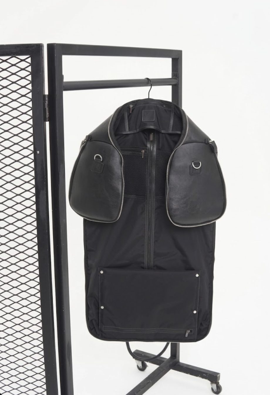 The weekender opened out into a hanging garment bag on a rolling rack