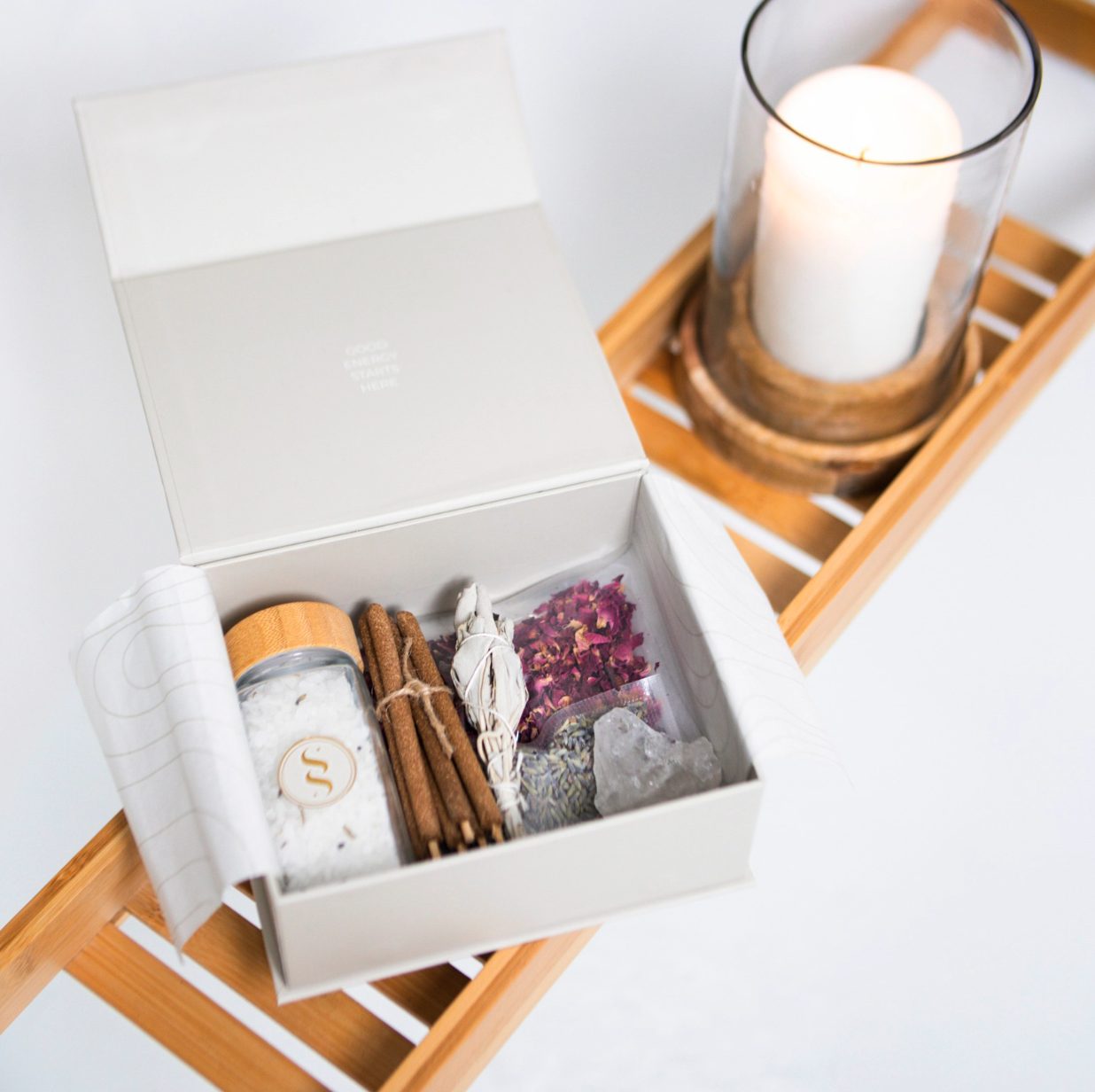 Gift box opened with bath salts, incense, sage, rose petals and quartz